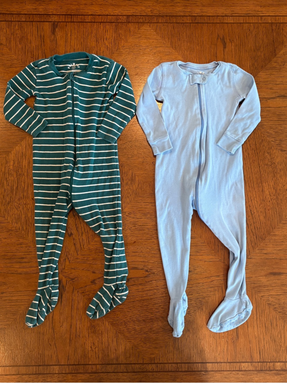Primary 100% cotton 
Green & White Striped and Light Blue Footed One-Pieces